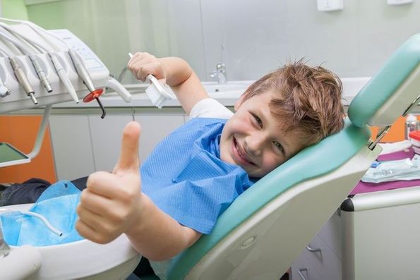 A child in a dentist's chair representing the young patients of general dentistry provider Byrd Adkins D.D.S. Smile Company in Amarillo, TX