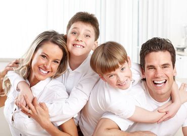 A smiling family representing full mouth reconstruction by dental services provider Byrd Adkins D.D.S. Smile Company in Amarillo, TX