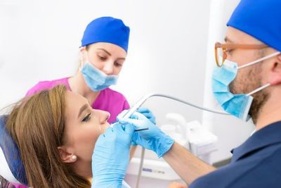 Dental professionals working on a patient representing tooth extractions by dental services office Byrd Adkins D.D.S. Smile Company in Amarillo, TX