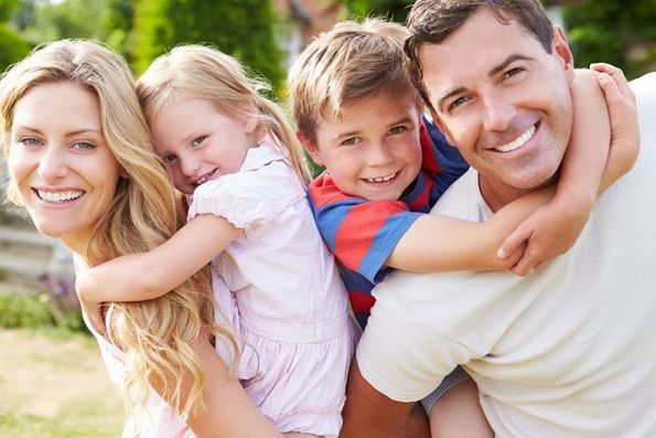 A smiling family representing the clientele of dental services provider Byrd Adkins D.D.S. Smile Company in Amarillo, TX